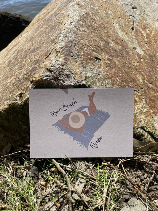 Laying woman, Main beach Noosa, ecofriendly postcard